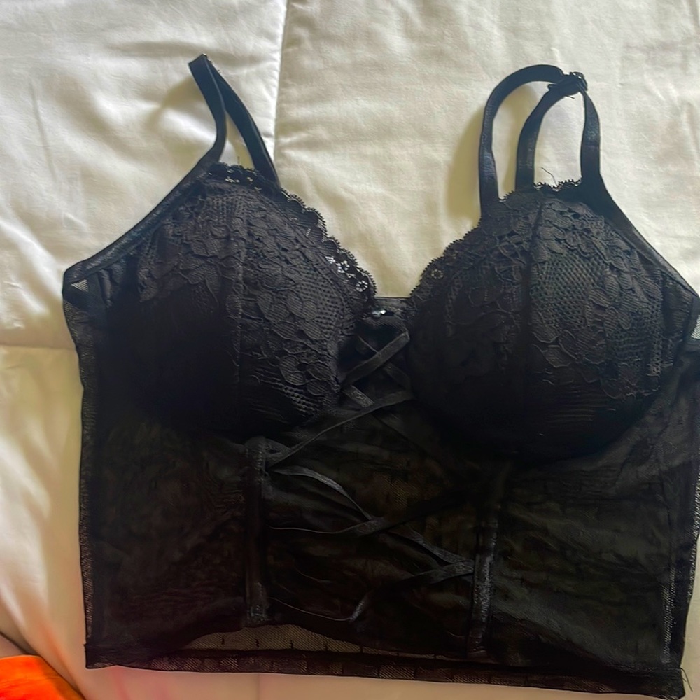 Black lace crop top with padding and adjustable straps.